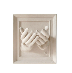 White sculptural wall art featuring two hands cupped together in a square frame, modern home décor