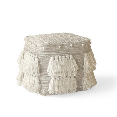 Hexagonal ottoman with tassels on a white background