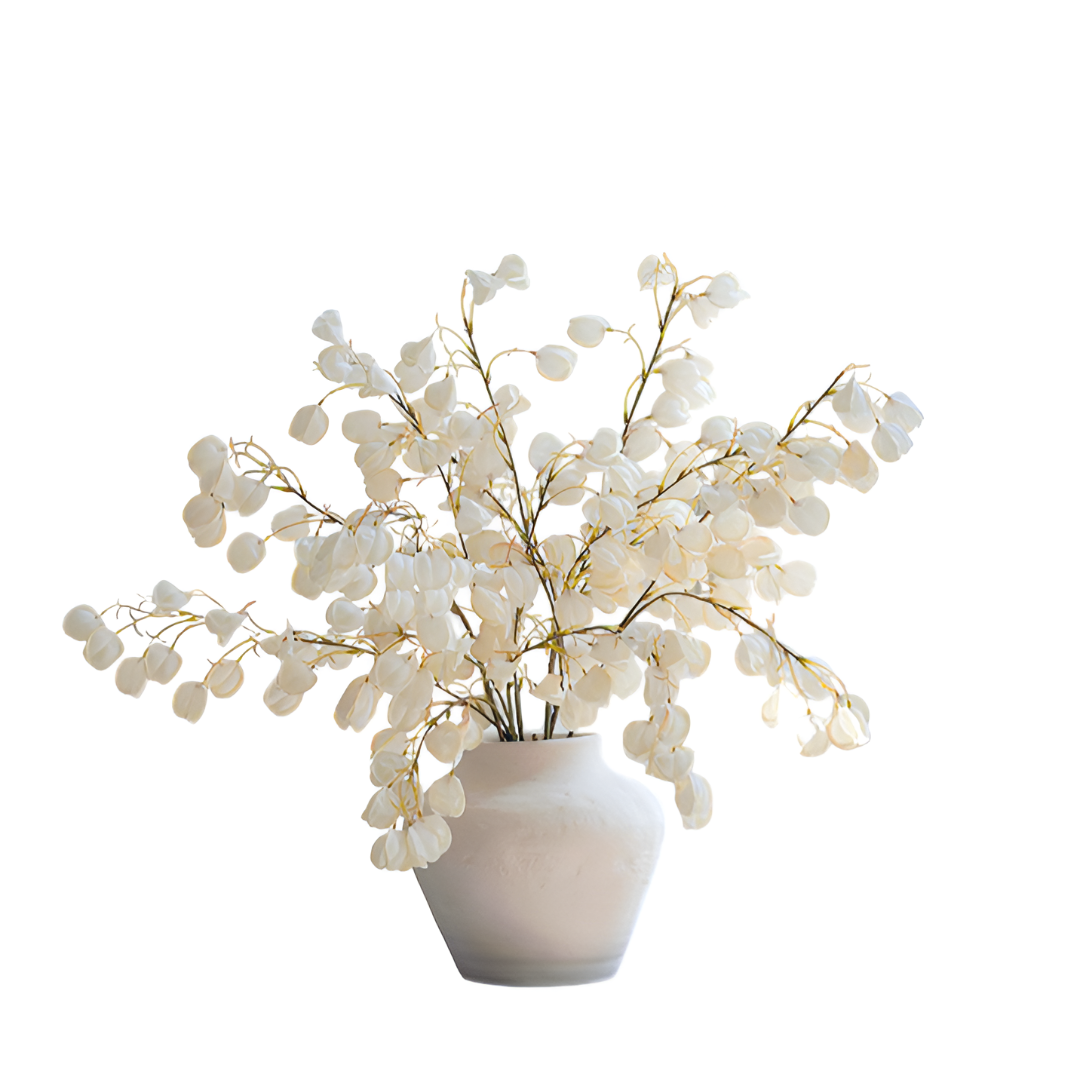 White artificial flower arrangement in a white vase on a white background