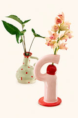 Ceramic multi-geometric vase by UNBELDI featuring a modern design with colorful geometric patterns on a white background.