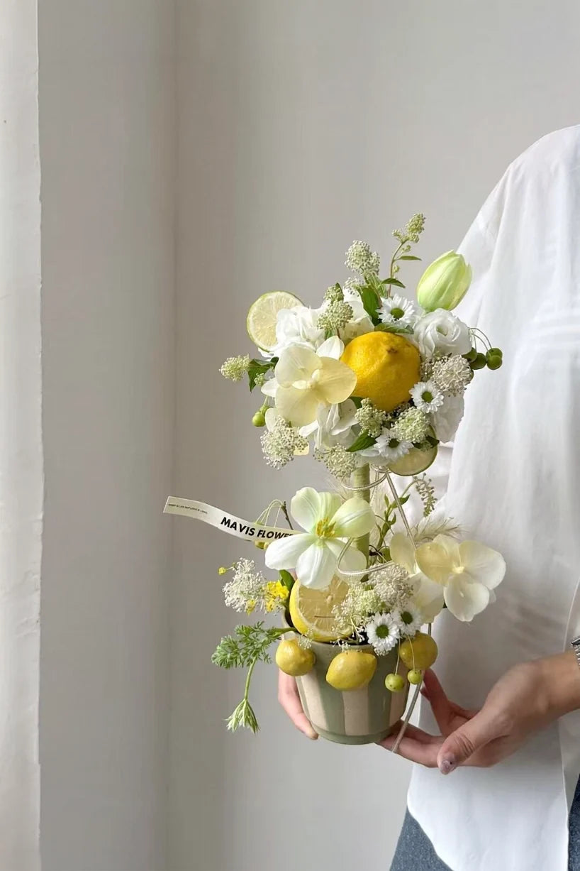 Three-lemon ceramic flower pot by TRLab Shop featuring a bright yellow lemon design and a classic round shape.