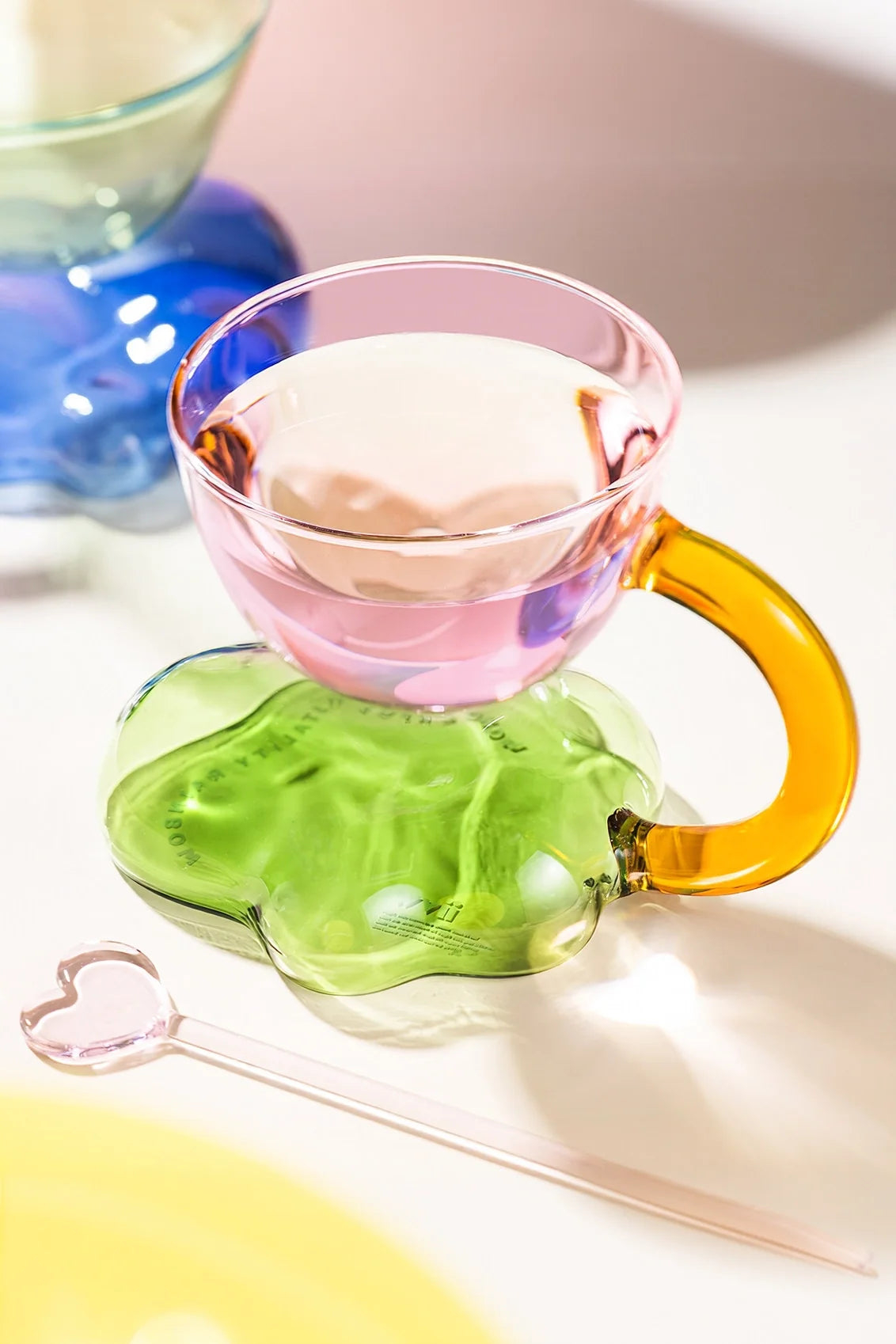 Floating cloud-shaped glass coffee cup by TRLab Shop, showcasing a clear, modern design with a smooth, rounded shape.