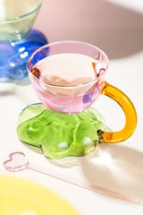 Floating cloud-shaped glass coffee cup by TRLab Shop, showcasing a clear, modern design with a smooth, rounded shape.