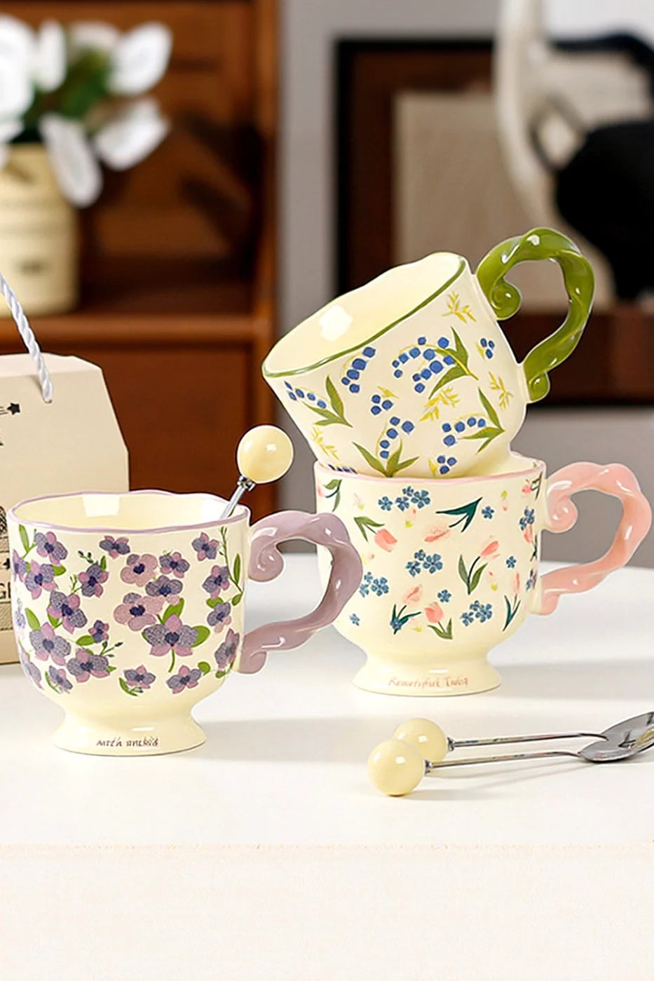 Floral twisted-handle ceramic mug with colorful flower design, durable white ceramic, ideal for hot beverages.