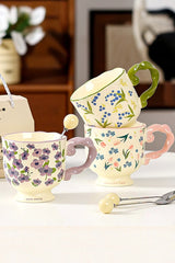 Floral twisted-handle ceramic mug with colorful flower design, durable white ceramic, ideal for hot beverages.