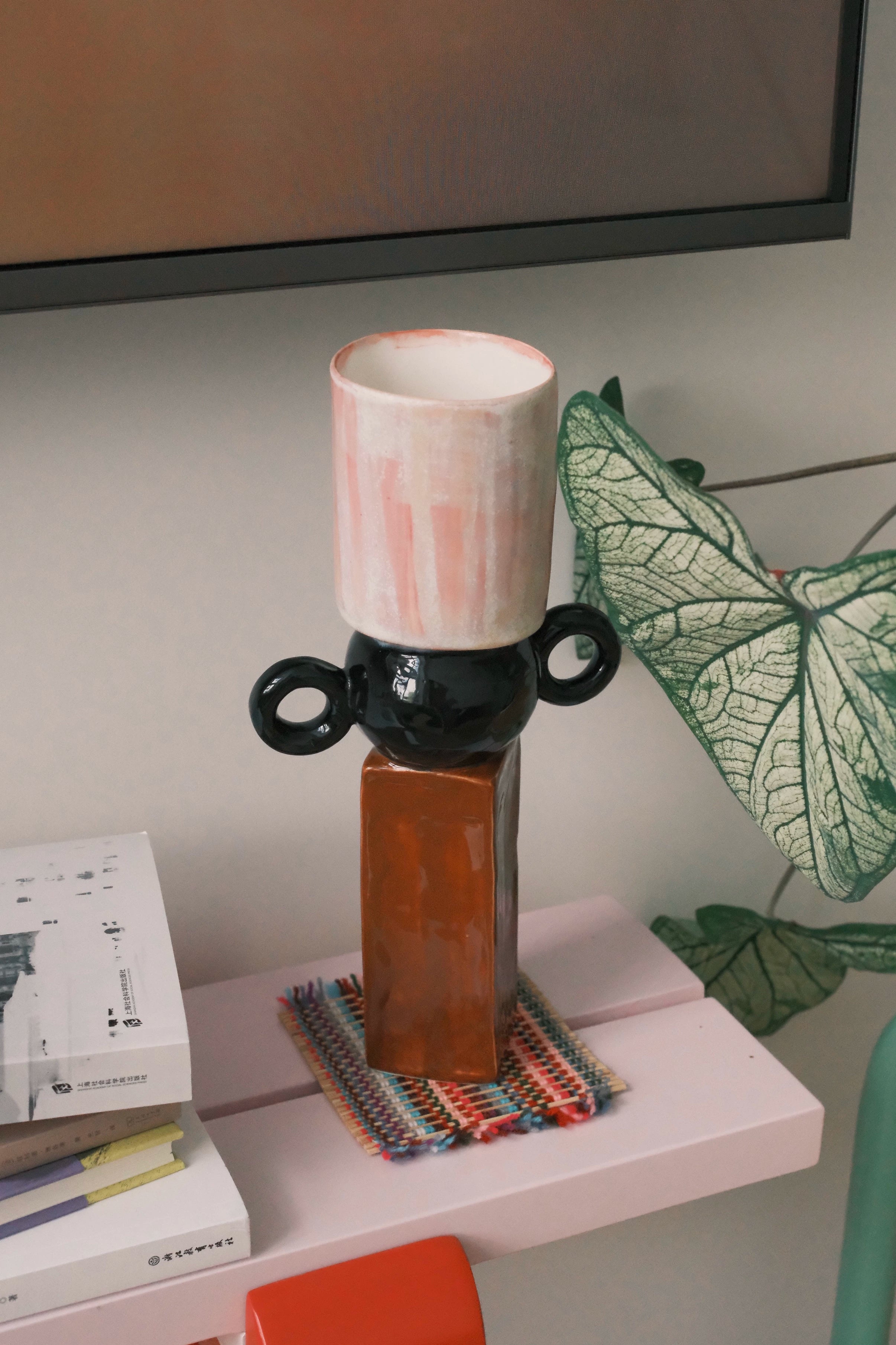 Ceramic multi-geometric vase from UNBELDI collection featuring colorful, modern design with angular patterns.