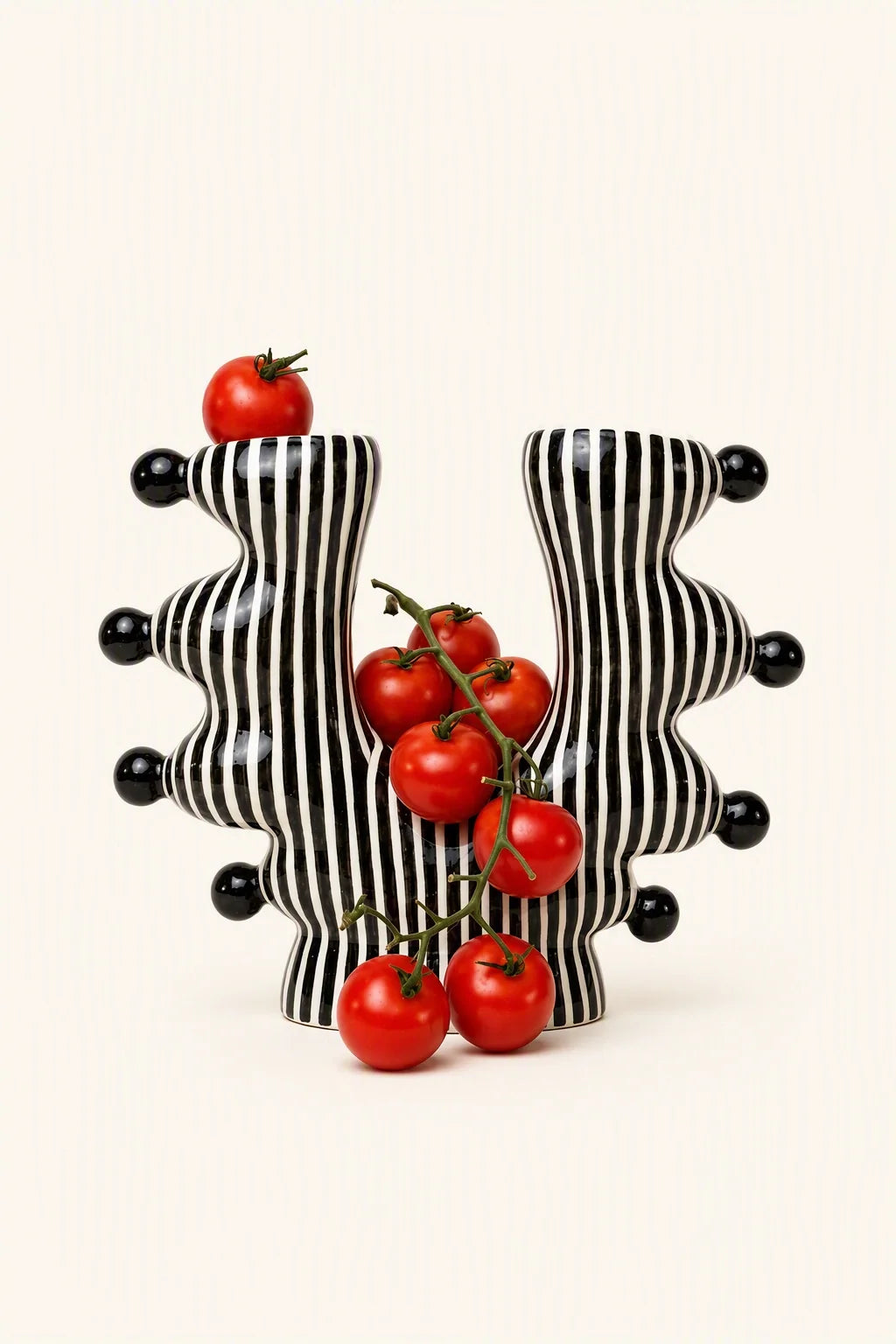 UNBELDI ceramic U-shaped vase with a smooth, glossy finish, showcasing its modern design and elegant curves.